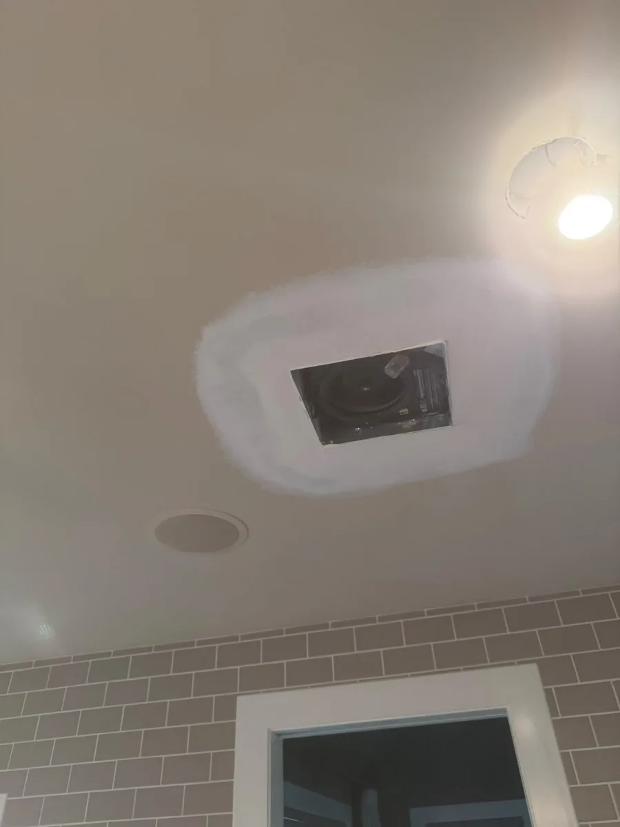 Drywall patching in progress around bathroom ceiling vent, Calgary