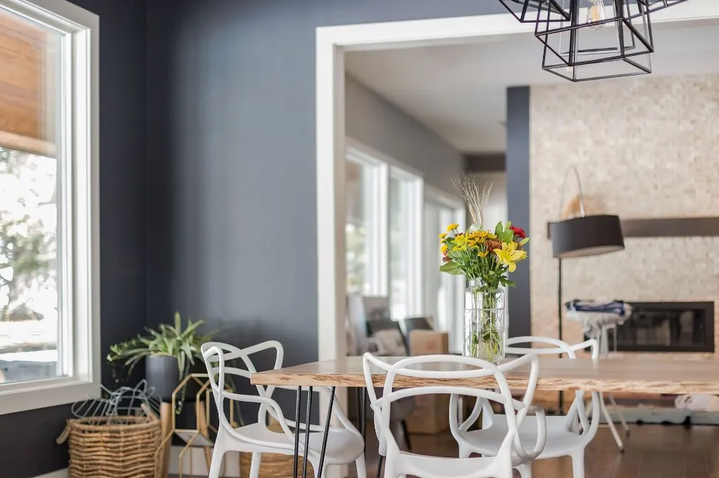 Dining room with blue accent wall paint in Calgary