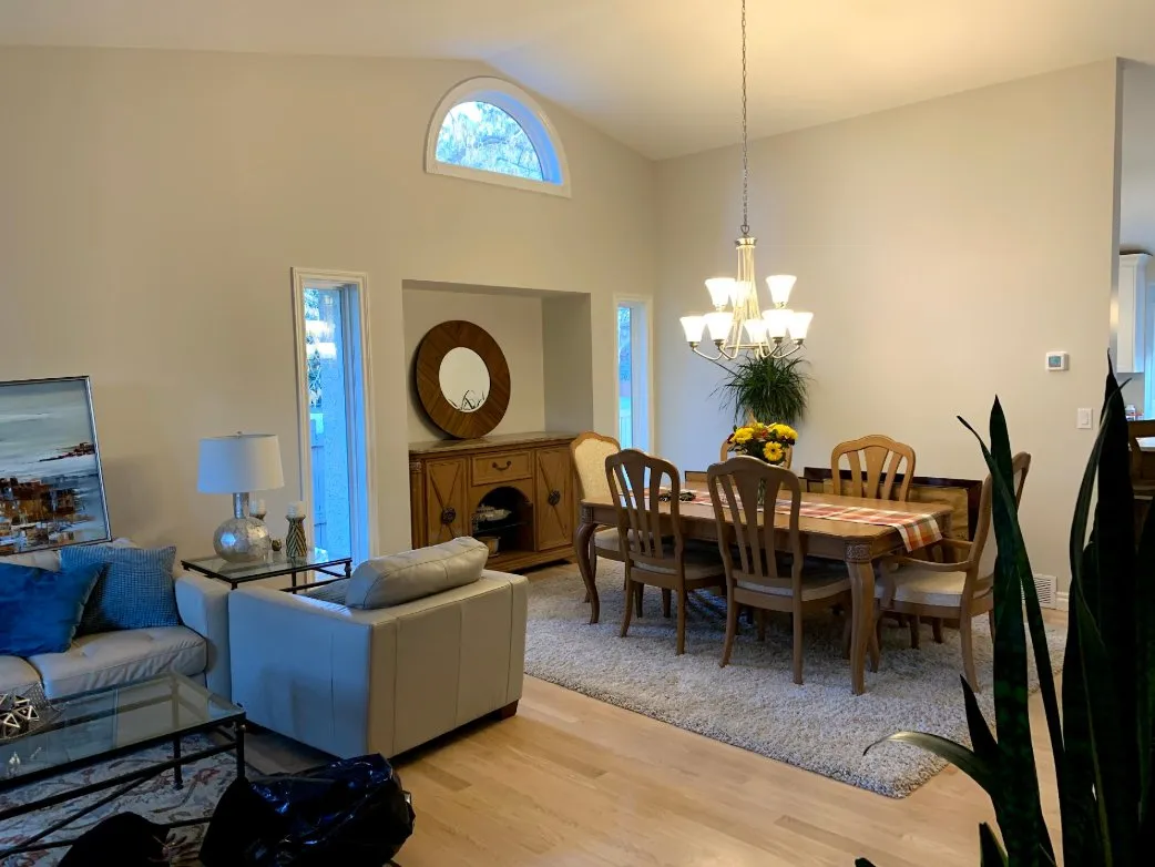 Dining room with freshly painted walls and chandelier in Calgary