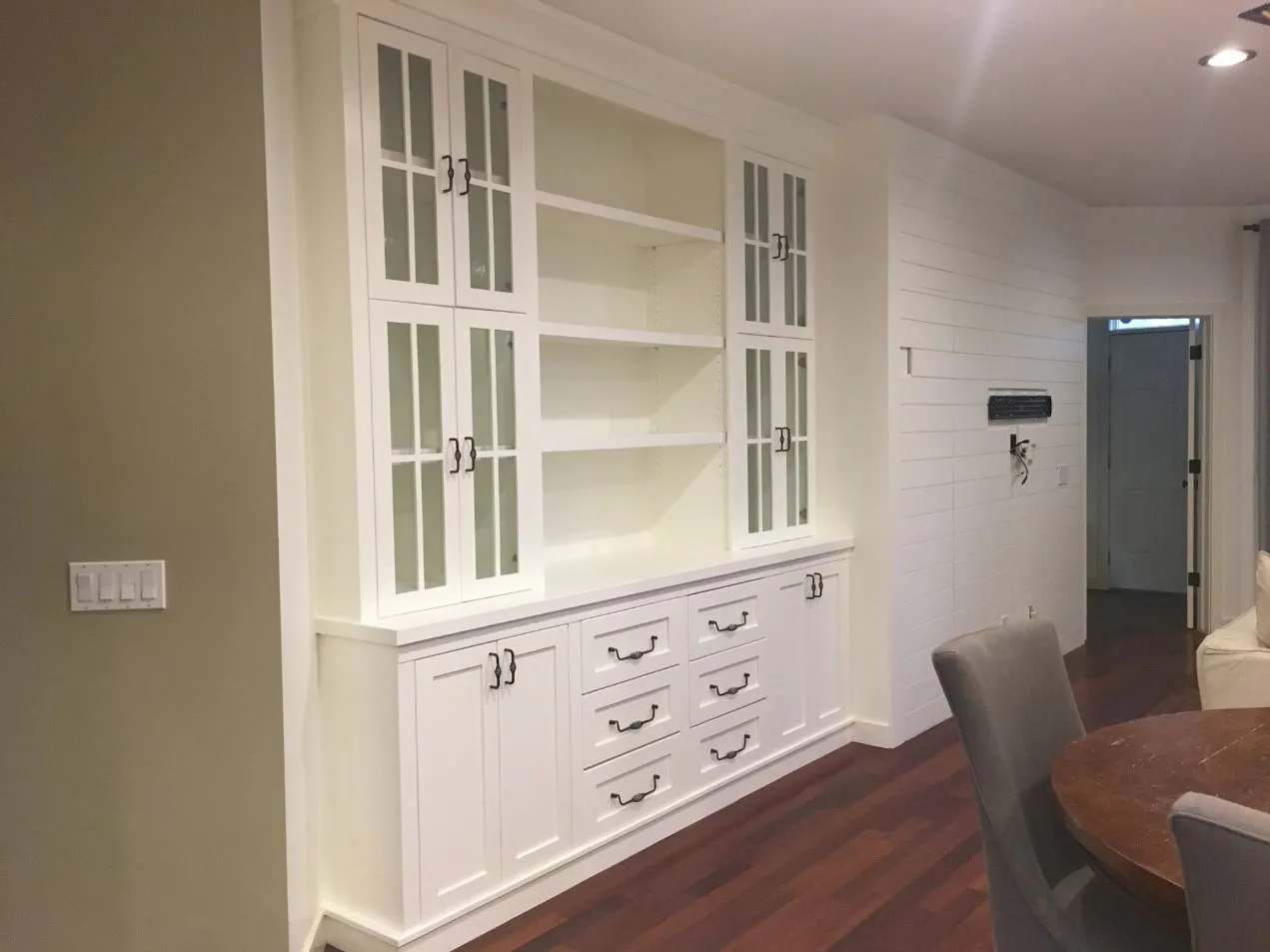 Dining room with freshly painted white built-in shelves in Calgary