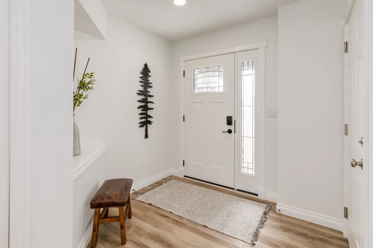 Entryway with fresh paint and white front door in Calgary