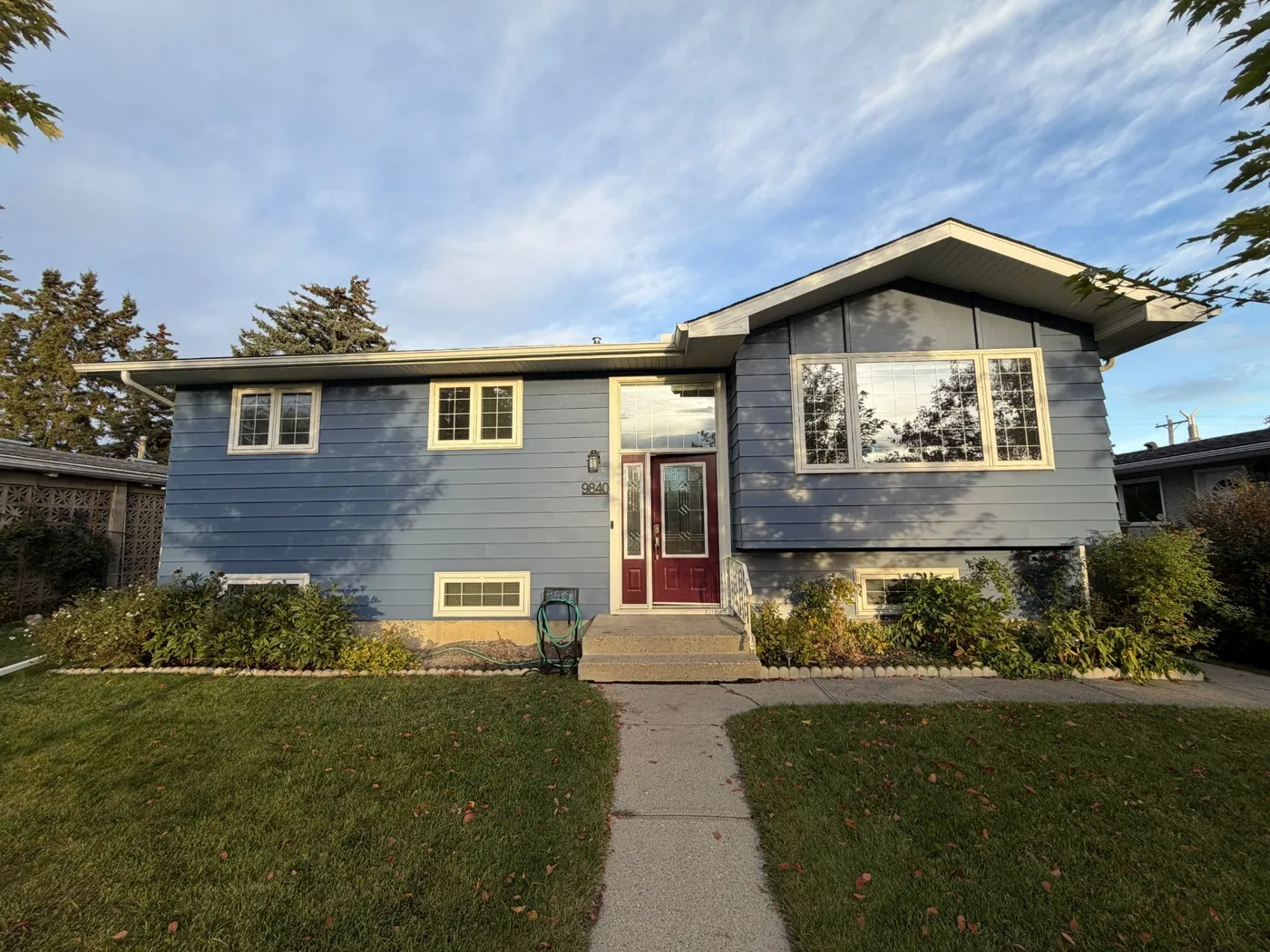 House exterior with fresh blue siding paint in Calgary
