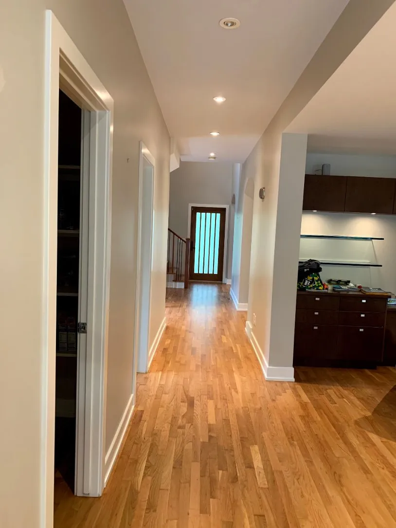 Hallway with fresh paint and hardwood floors in Calgary