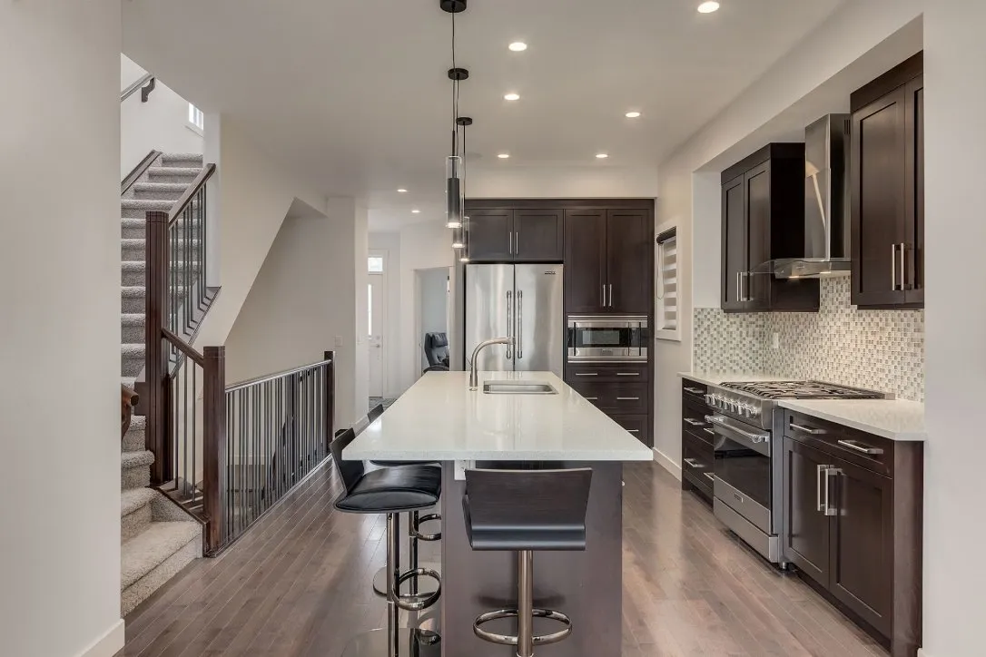 Kitchen with dark painted cabinets and large island in Calgary