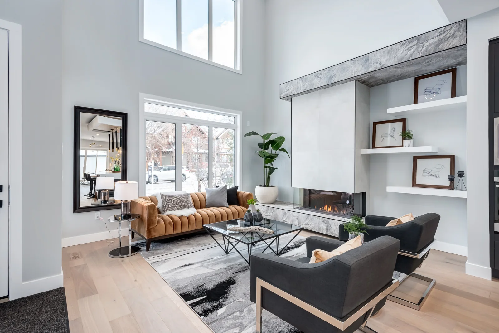 Living room with a stone fireplace in a Calgary home painted by MV Painting Inc.