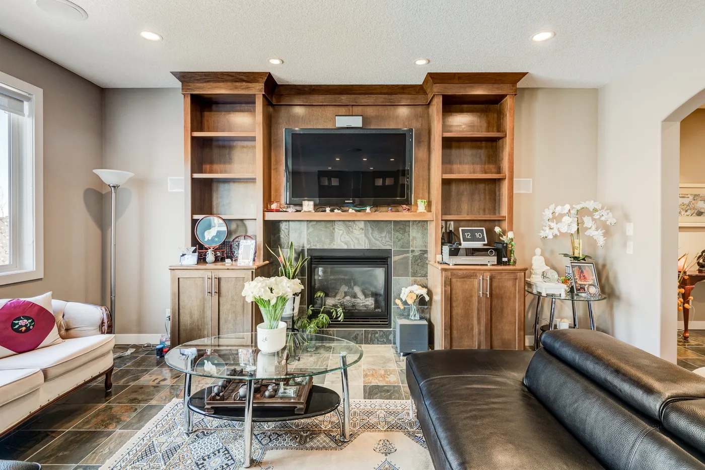 Living room with painted walls, fireplace and wood built-ins in Calgary