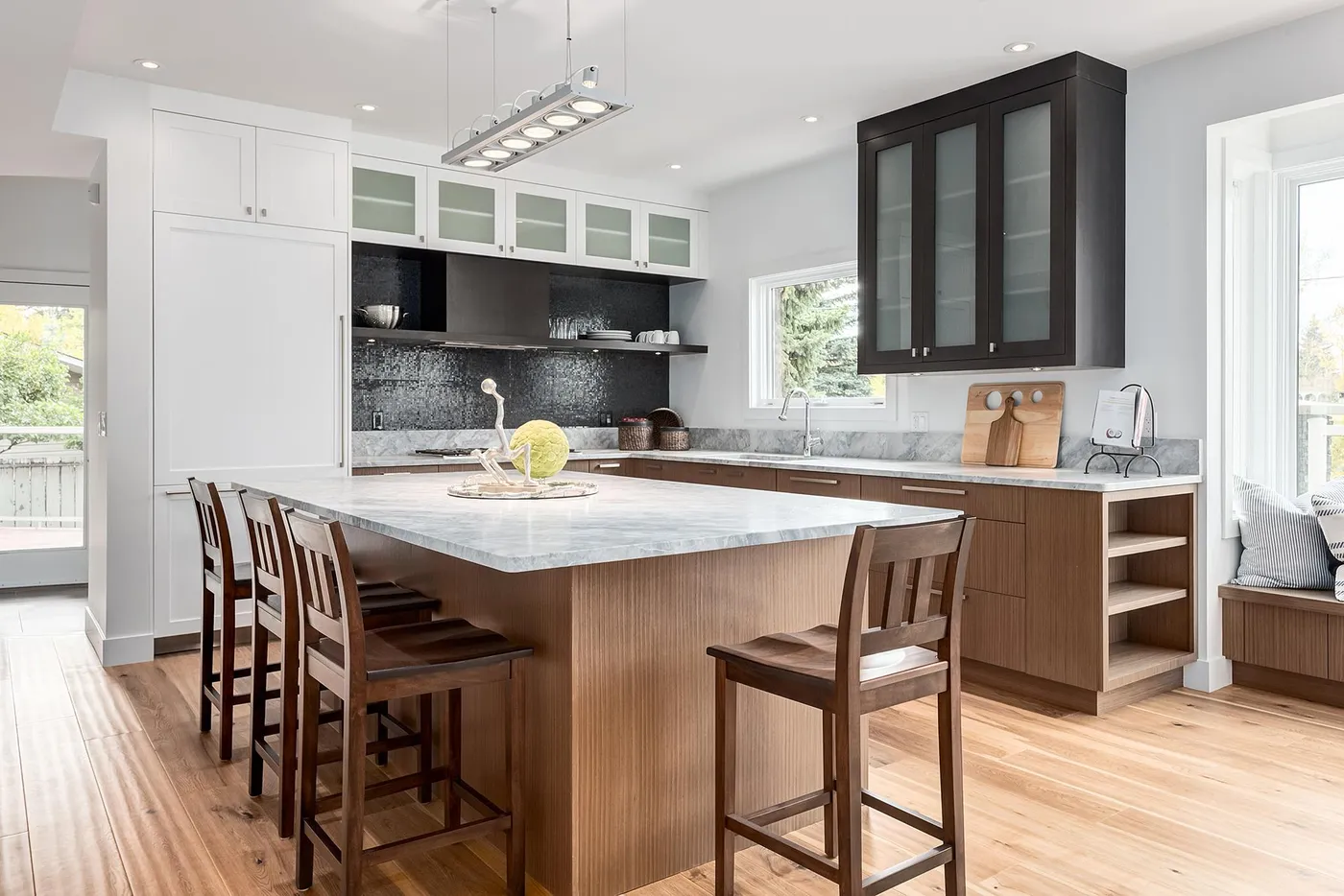 Modern kitchen with painted walls and dark wood island in Calgary