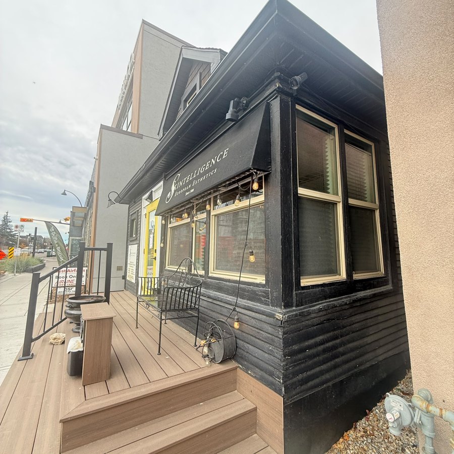 Commercial building exterior painted black, before repainting in Calgary
