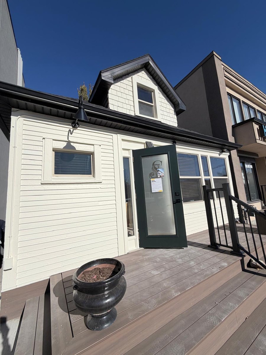 Repainted commercial exterior with front deck in Calgary