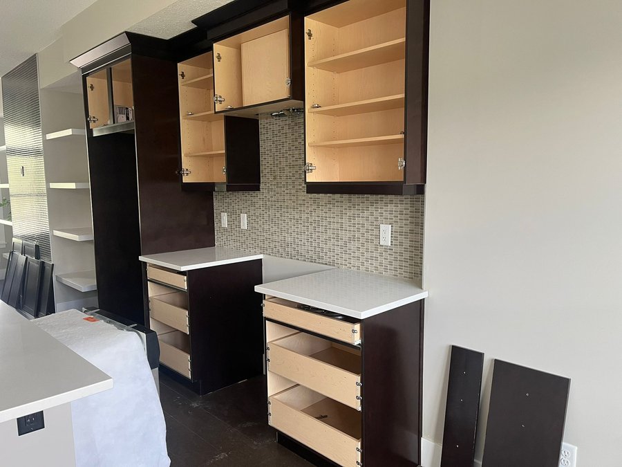 Cabinet frames with doors and drawers removed during kitchen cabinet refinishing