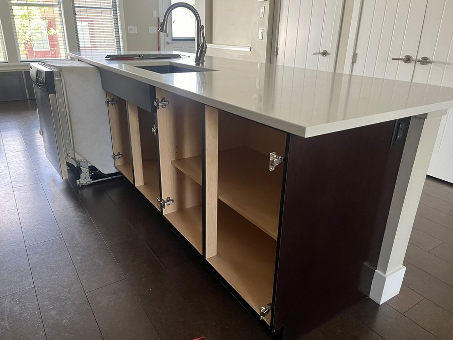 Kitchen island cabinets with doors removed during refinishing
