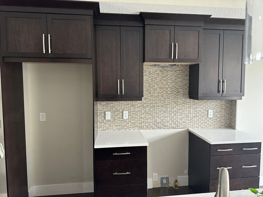 Dark espresso kitchen cabinets before refinishing in Quarry Park, Calgary