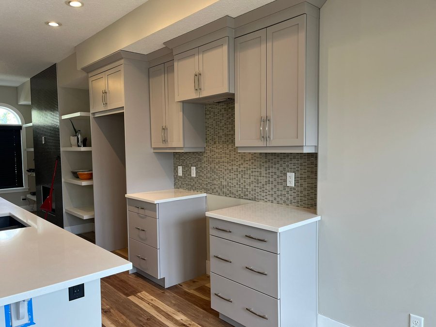 Kitchen cabinets refinished in a light warm off-white in Quarry Park, Calgary