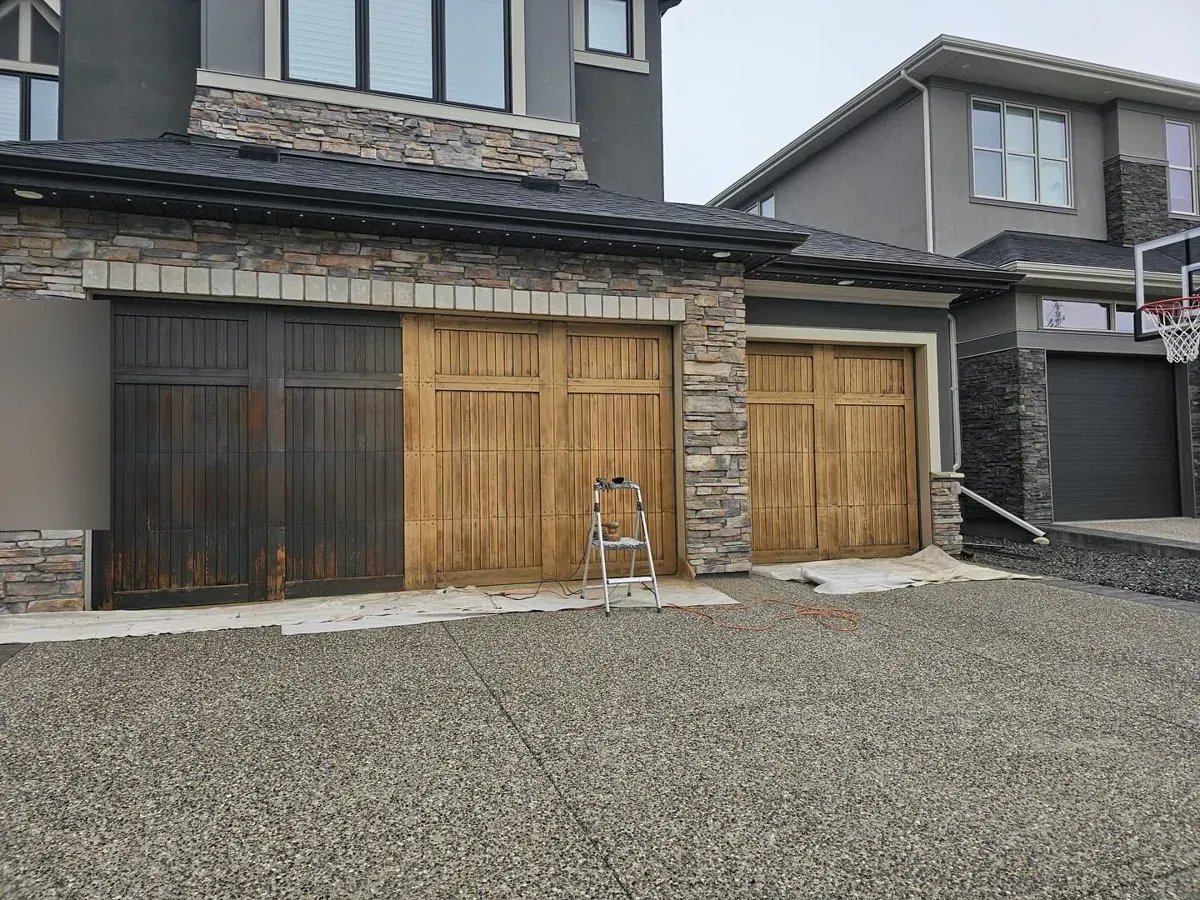 Garage door half stripped and half refinished, detail of the work in Cougar Ridge, Calgary