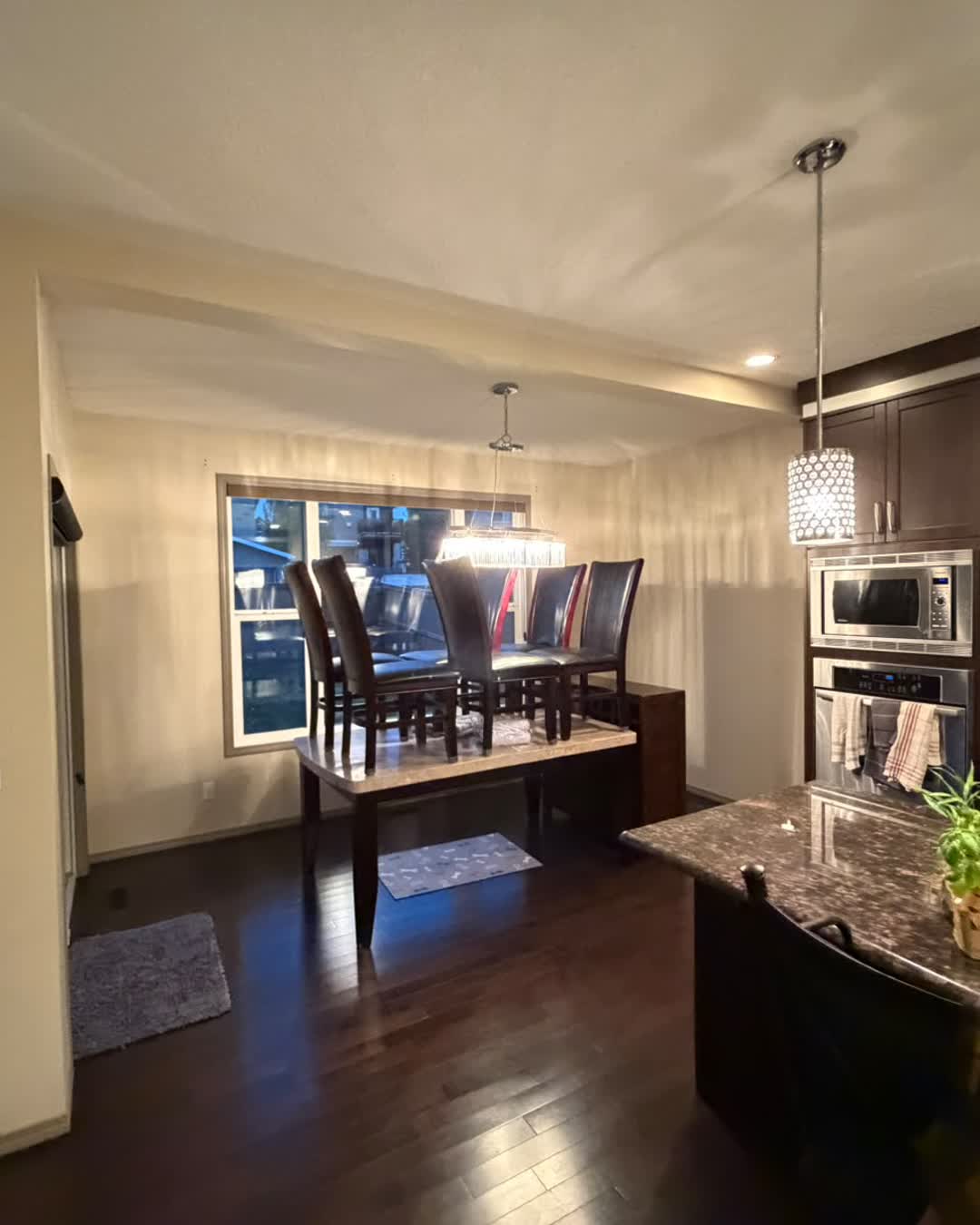 Dining room with freshly painted walls and protected furniture during the Cranston interior repaint, Calgary