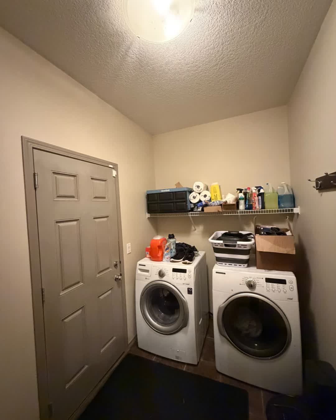 Laundry room with freshly painted door and walls during the Cranston interior repaint, Calgary