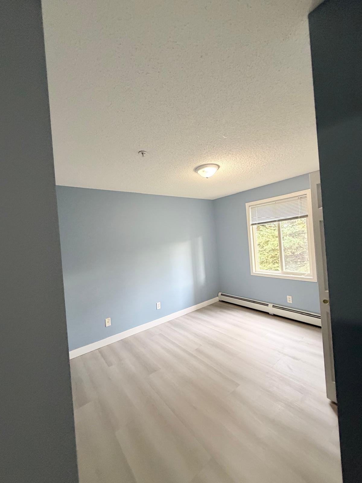 Repainted second bedroom in an Evergreen condo, Calgary