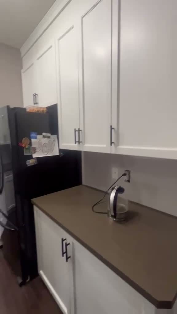 Finished white kitchen cabinets after refinishing in Kincora, Calgary