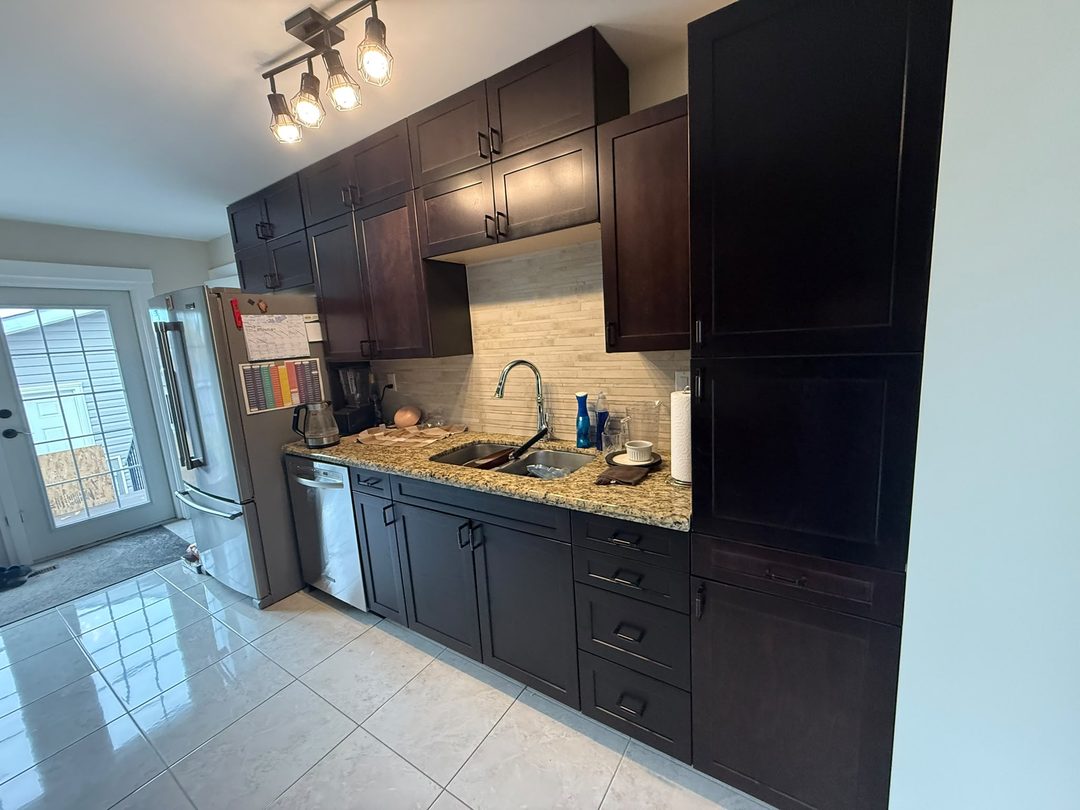 Refinished espresso kitchen cabinets at the sink wall in Maple Ridge, Calgary