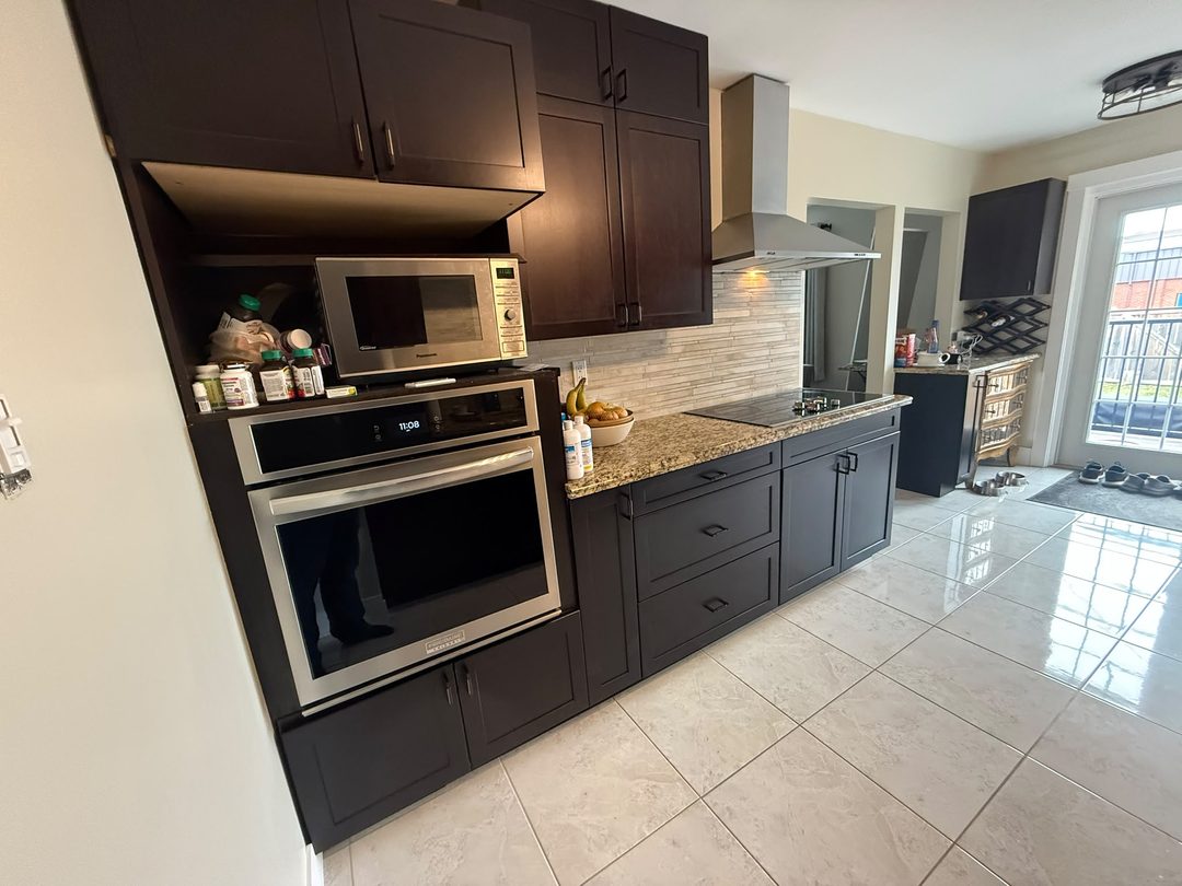 Refinished espresso kitchen cabinets after a colour-match restoration in Maple Ridge, Calgary