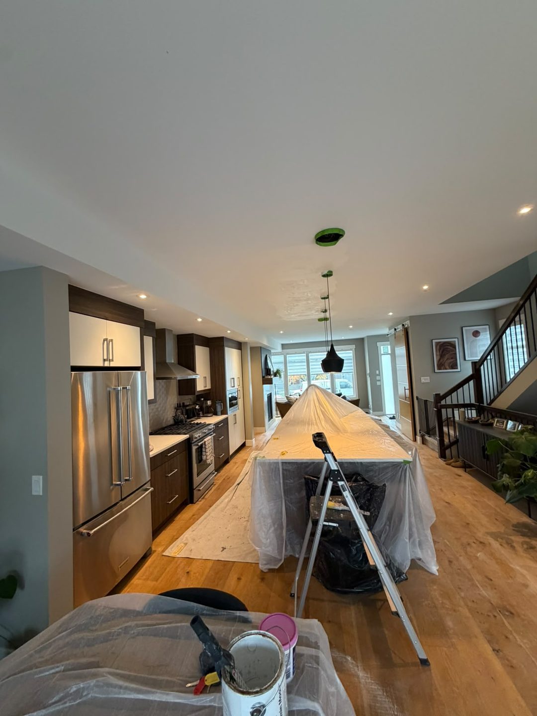 Drywall repair and full repaint of two water-damaged ceilings in Mount Pleasant, Calgary: one with mould from water damage, one with drywall replaced as a preventive measure. Damaged sections cut out, new boards installed, seams finished smooth, primed and painted with a full two-coat application.