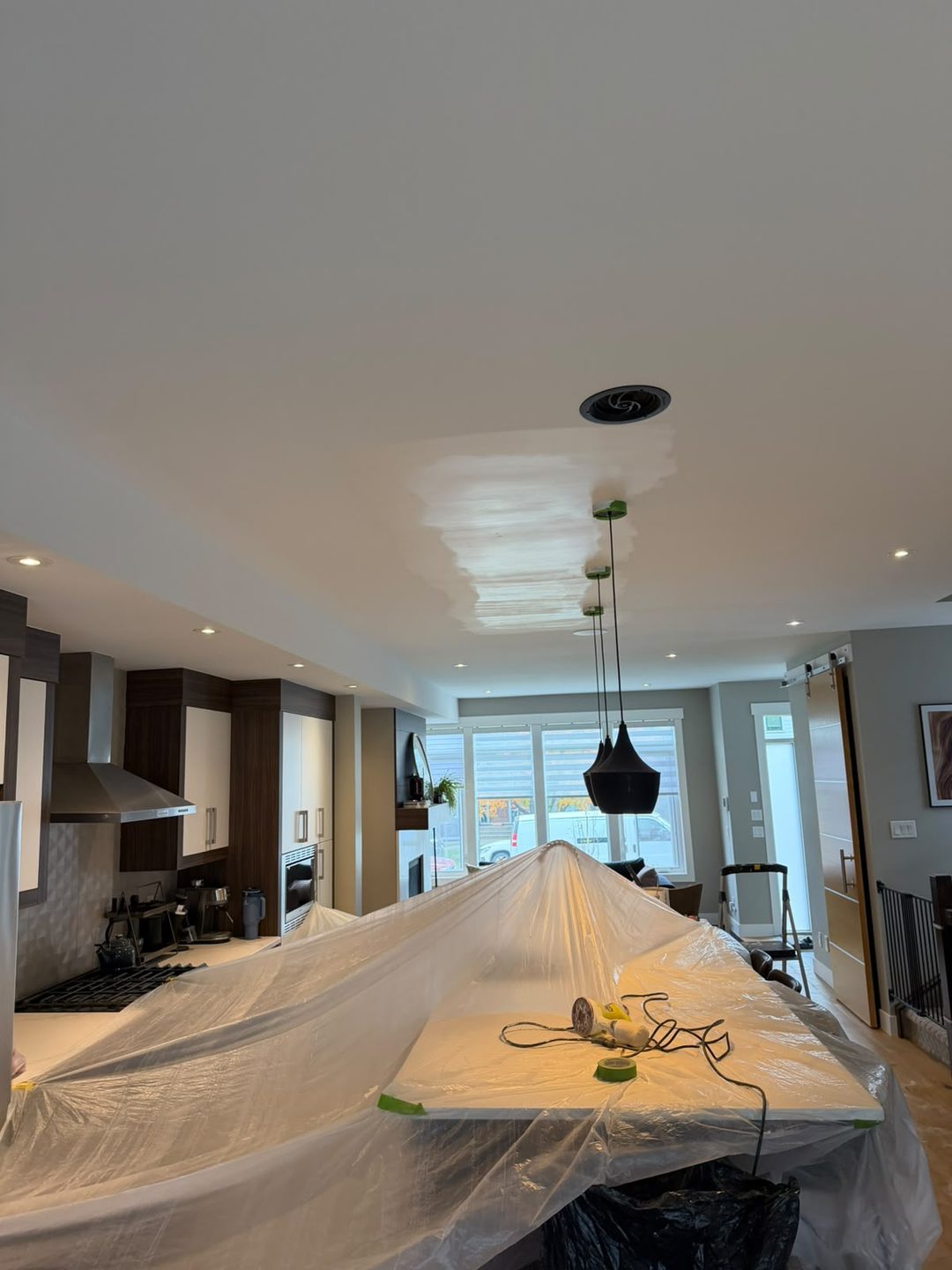 Primed ceiling patch masked and ready for painting in Mount Pleasant, Calgary