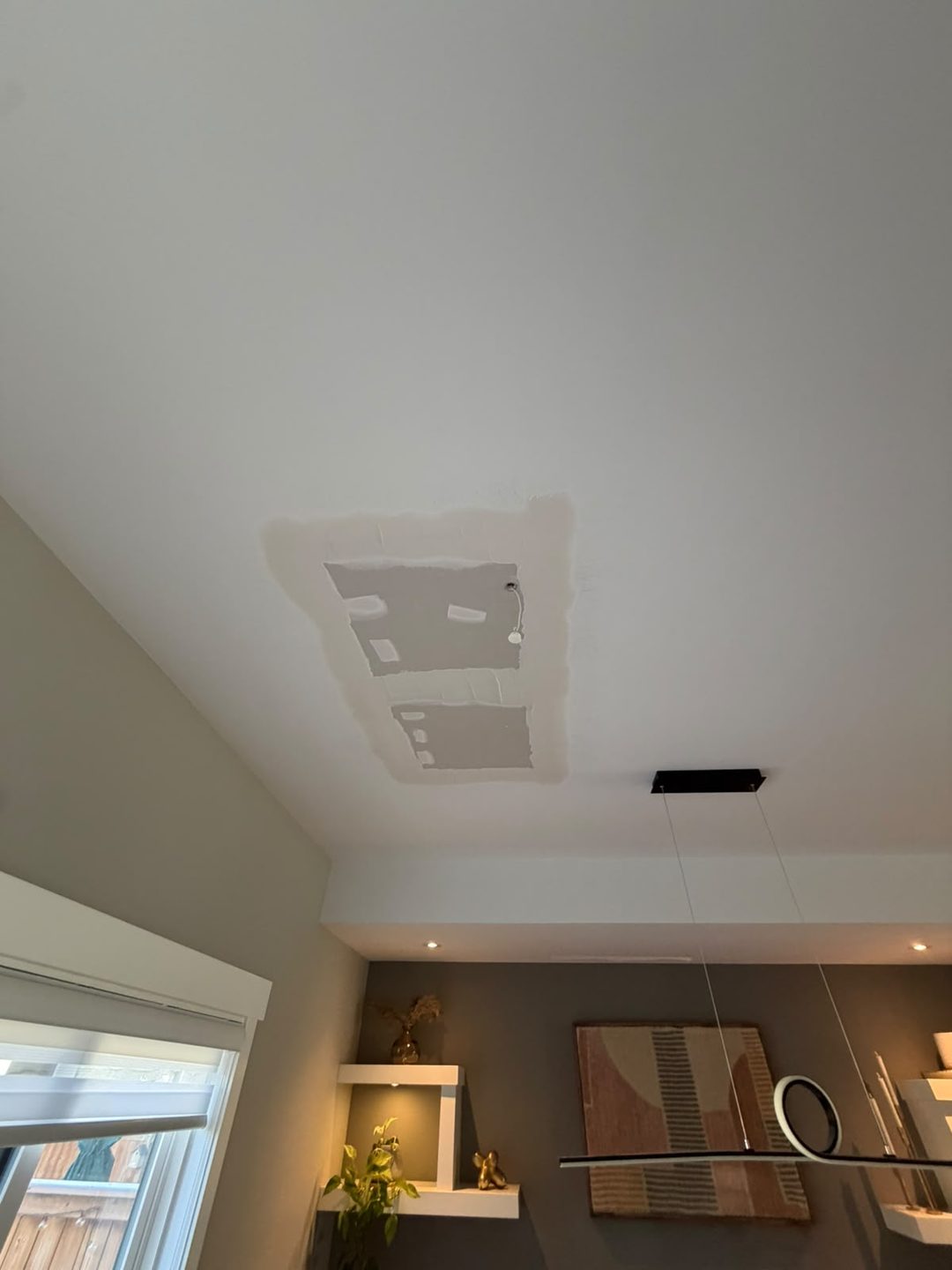 Mudded drywall patch on a dining room ceiling in Mount Pleasant, Calgary