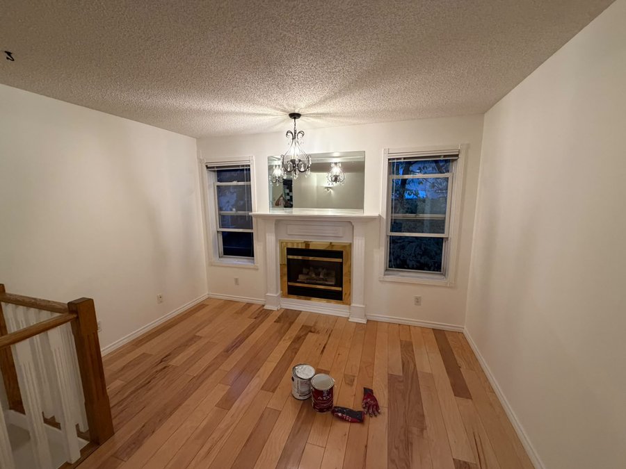 Living room repainted in Benjamin Moore Simply White in Mount Pleasant, Calgary