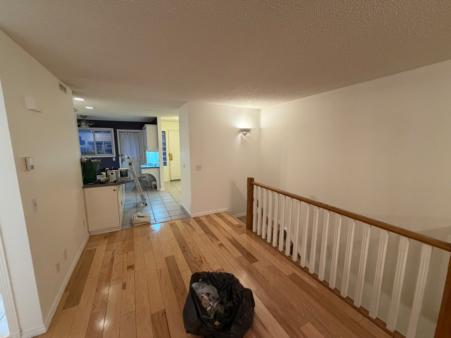 Upper landing repainted in Benjamin Moore Simply White in Mount Pleasant, Calgary