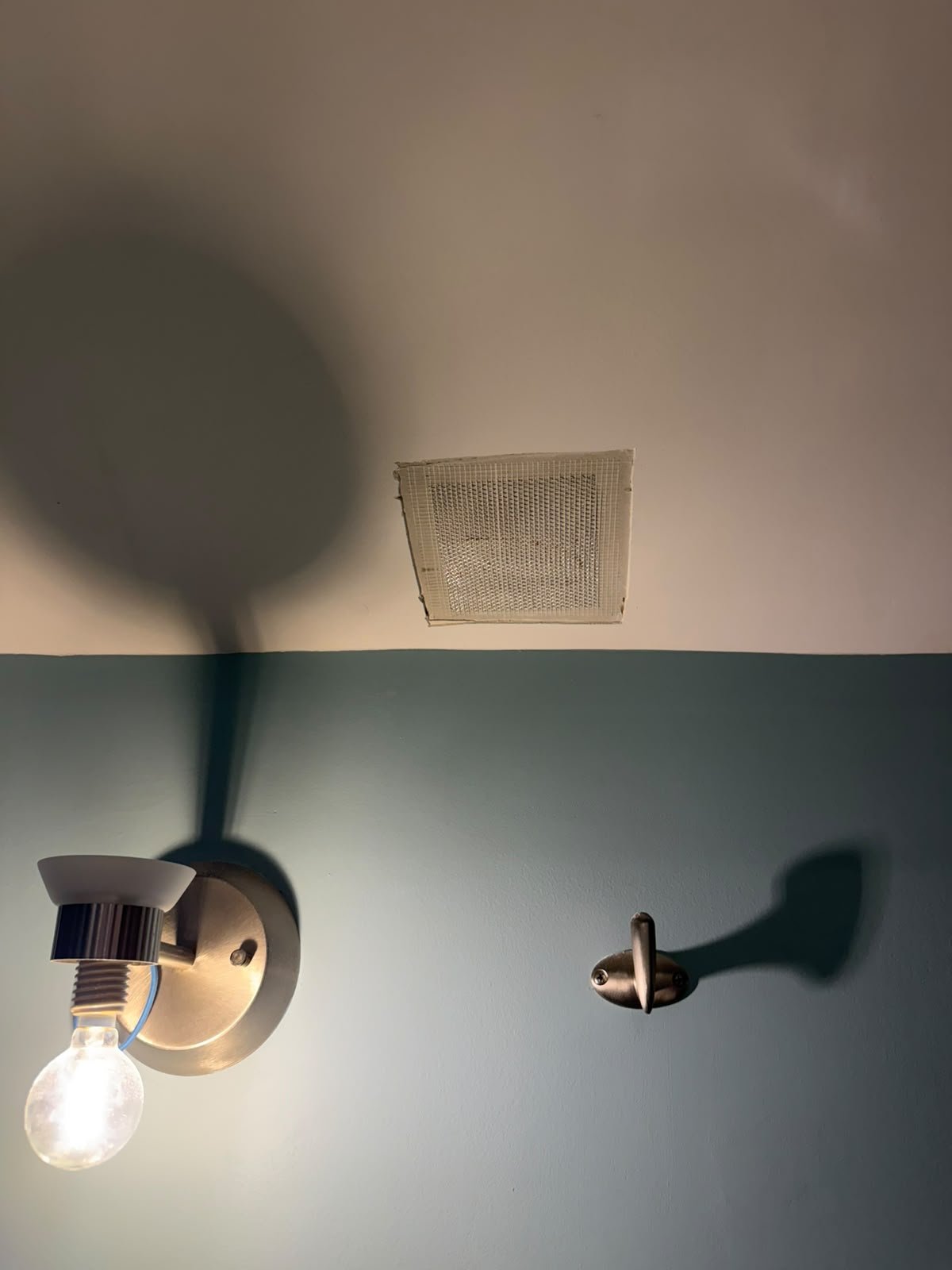 Bathroom ceiling drywall repair in Oakridge, Calgary: taped, mudded smooth and repainted.