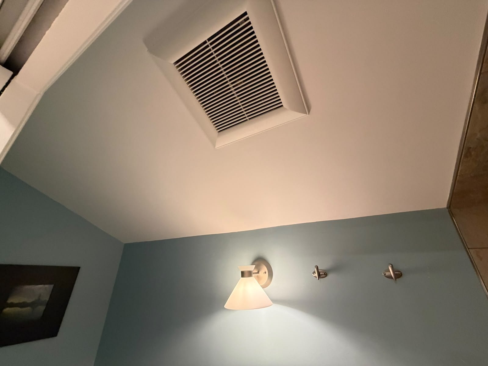 Finished repainted bathroom ceiling with ceiling fan in Oakridge, Calgary