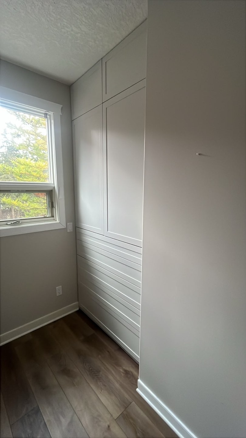 Built-in wardrobe installed with a flawless sprayed white finish in Three Sisters, Canmore