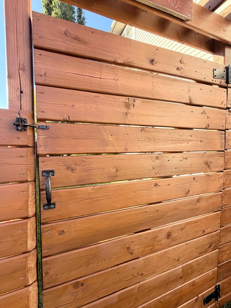 Stained wooden gate close-up in Springbank Hill, Calgary