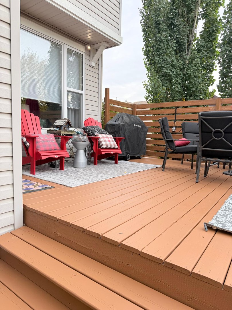 Stained deck with patio furniture in Springbank Hill, Calgary