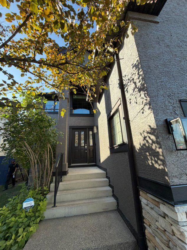 Stucco spray painting in progress in West Springs, Calgary