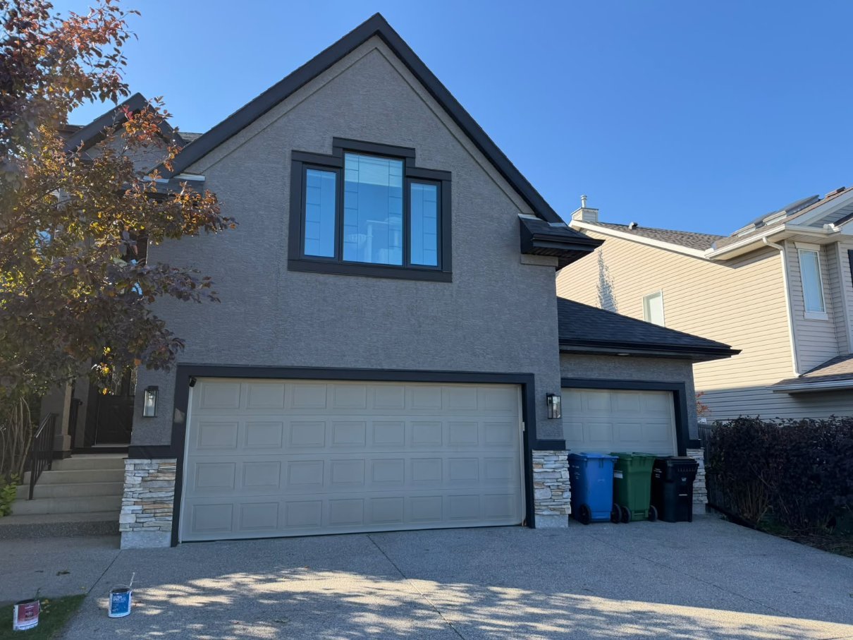 Finished sprayed stucco on the front of a home in West Springs, Calgary