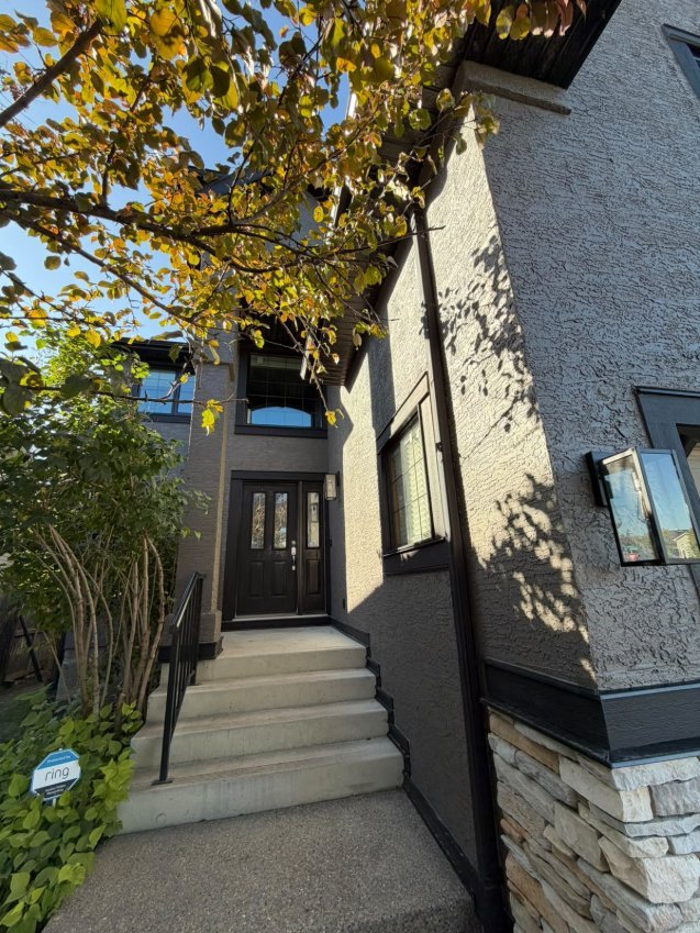 Finished sprayed stucco at the entry in West Springs, Calgary