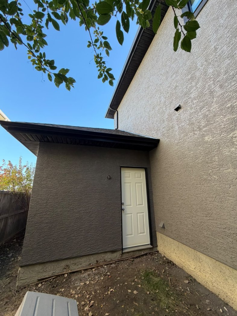 Detail of freshly sprayed stucco in West Springs, Calgary