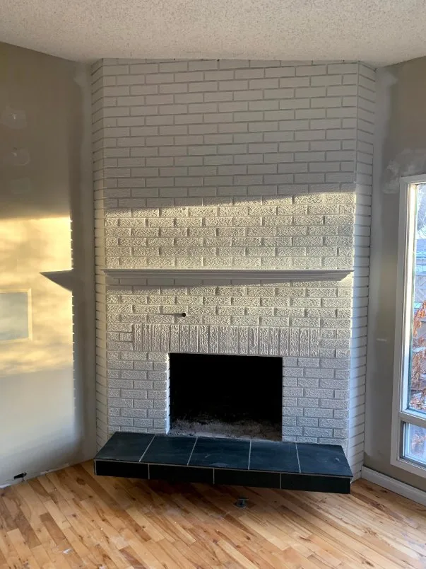 White painted brick fireplace in a Calgary home