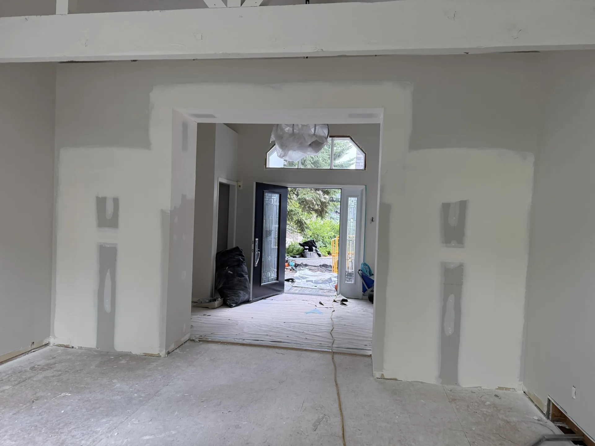 Drywall repair and painting in progress in a Calgary foyer