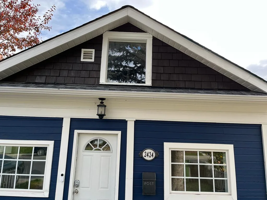 Blue house exterior with fresh paint by MV Painting Inc. in Calgary, Alberta